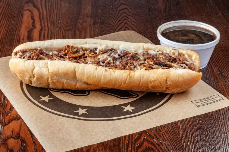 French Dip cheesesteak — beef, mozzarella, grilled onions, mushrooms with au jus on the side