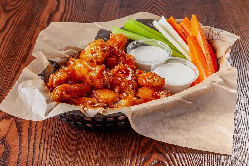 Traditional wings tossed in sauce with celery, carrots and ranch