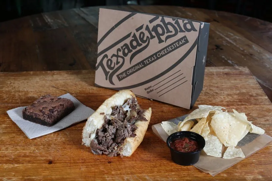 Texadelphia box lunch — cheesesteak, chips and salsa, and a brownie in a branded box