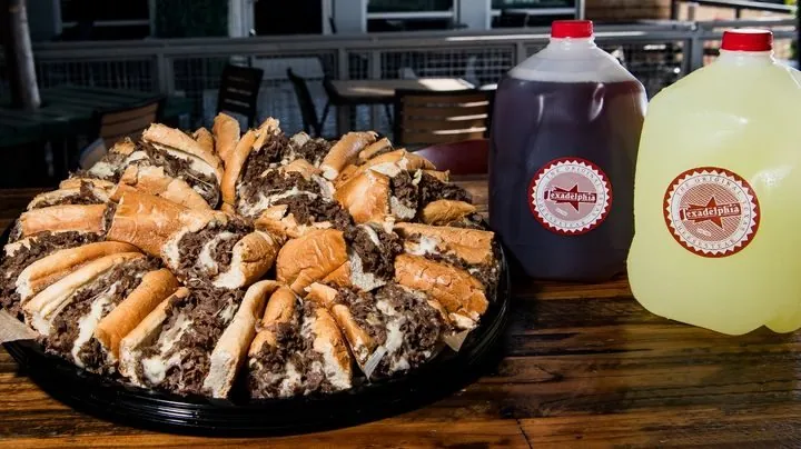 Texadelphia cheesesteak catering tray with gallon drinks